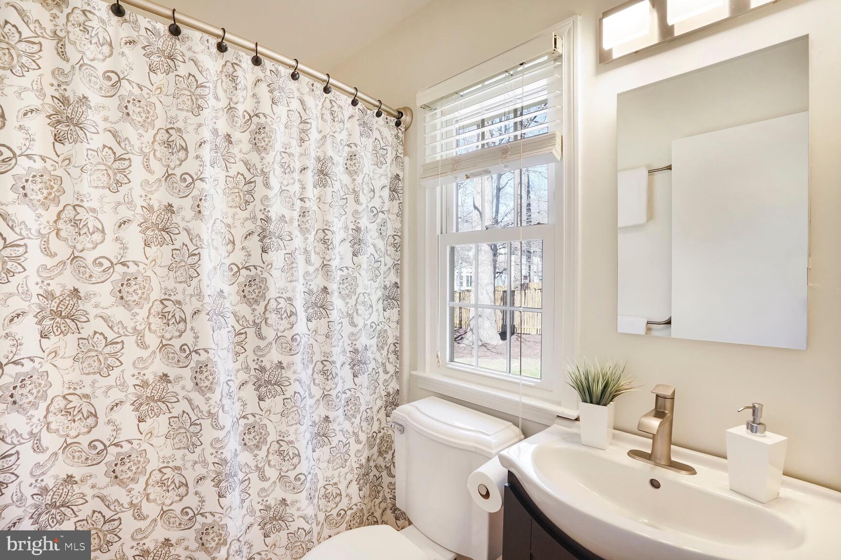 8618 Crestview Drive Fairfax, VA 22031 - Photo 26 of 33 a bathroom with a sink toilet and mirror