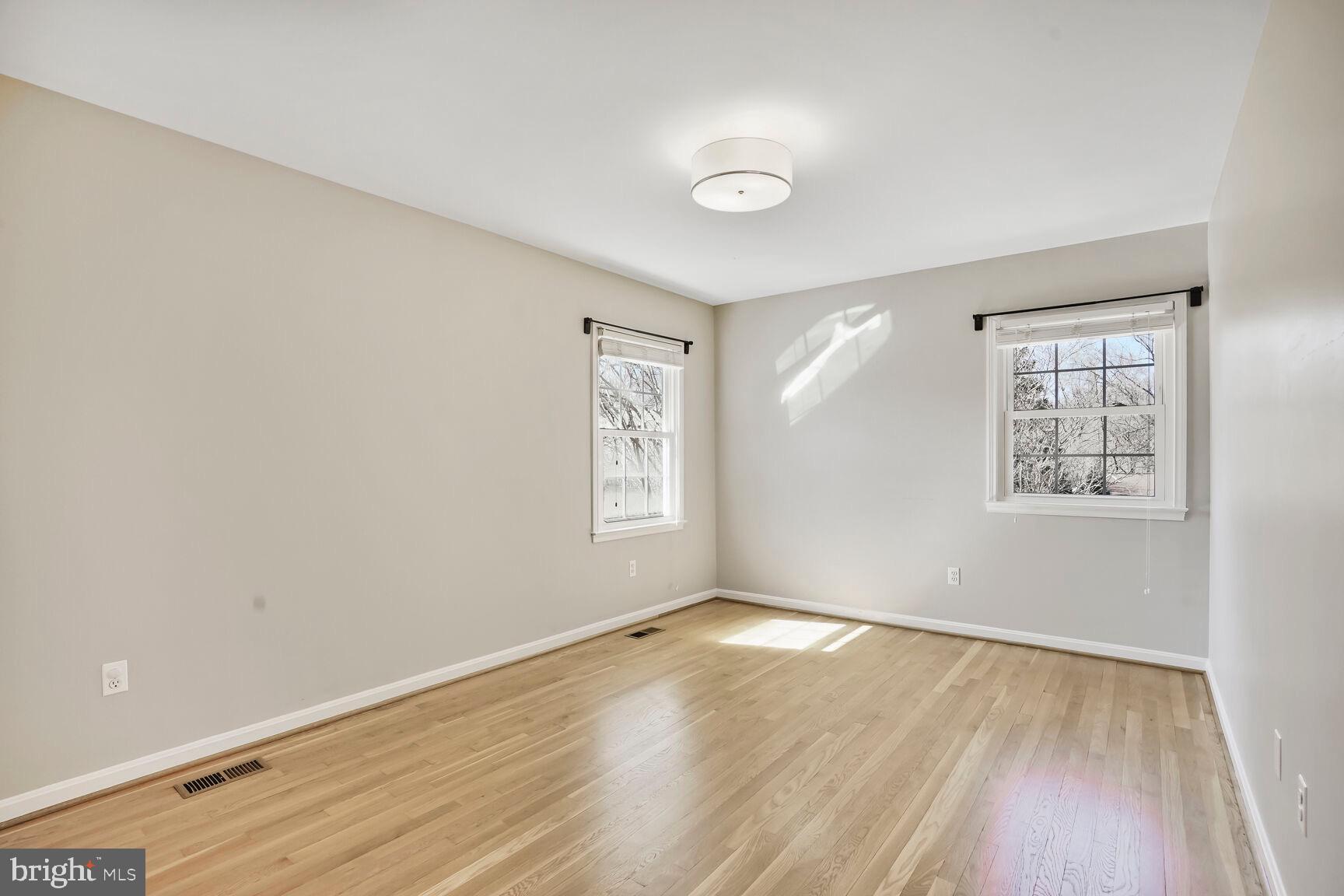 8618 Crestview Drive Fairfax, VA 22031 - Photo 28 of 33 an empty room with wooden floor and windows