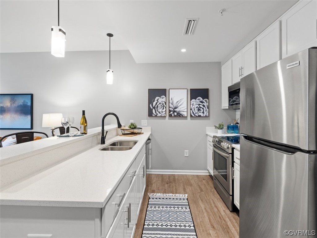 a kitchen with stainless steel appliances a refrigerator sink and stove