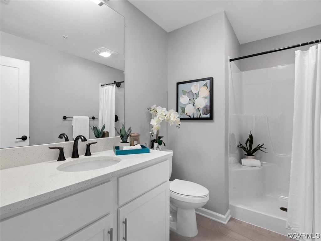1504 Ewing Park Loop, Unit 201 Midlothian, VA 23113 - Photo 11 of 20 a bathroom with a toilet sink and mirror