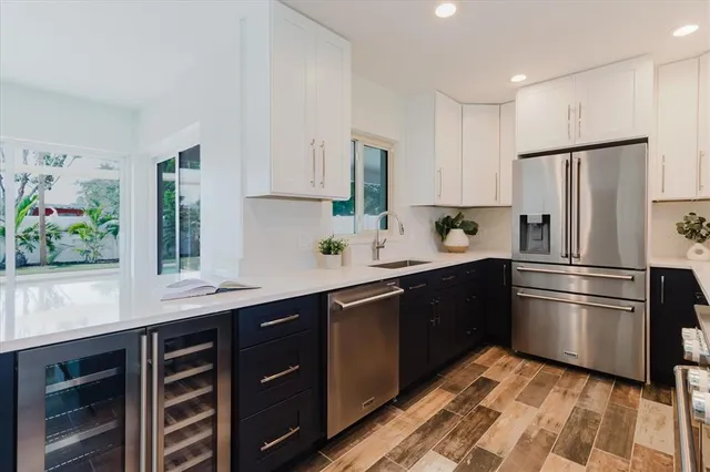 a kitchen with a sink stainless steel appliances and cabinets