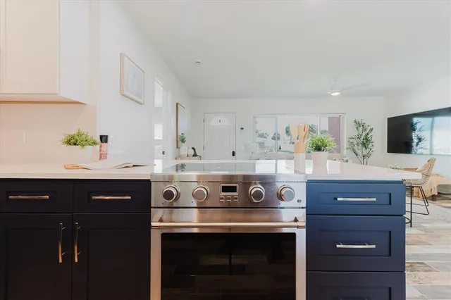 a view of cabinets a oven and a stove in a kitchen