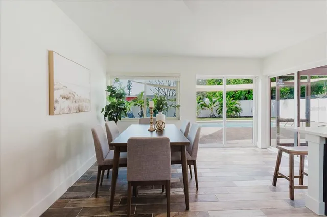 a view of a dining room with furniture and a potted plant
