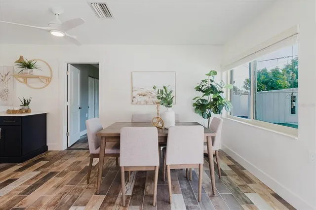 a view of a dining room with furniture window and wooden floor