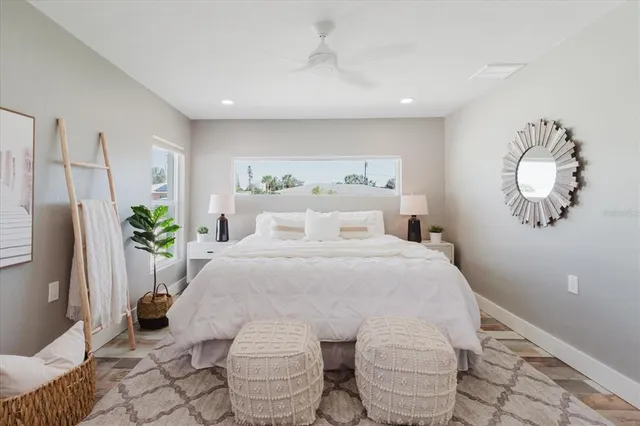 a bedroom with a bed and a potted plant