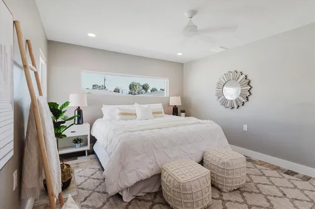 a bedroom with a bed and a painting on the wall