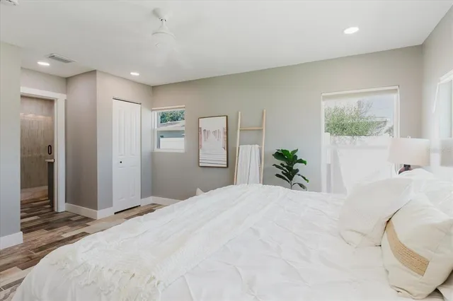 a bedroom with a large bed and a chandelier