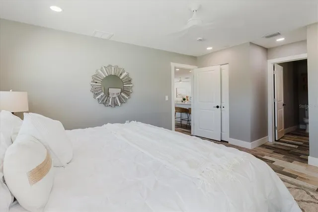 a bedroom with a large bed and a chandelier