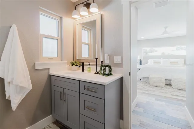 a bathroom with a sink a mirror and a shower