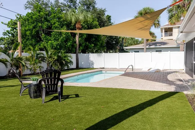 a view of yard with swimming pool and sitting area
