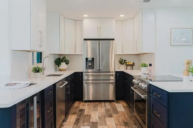 a kitchen with a sink stainless steel appliances and cabinets