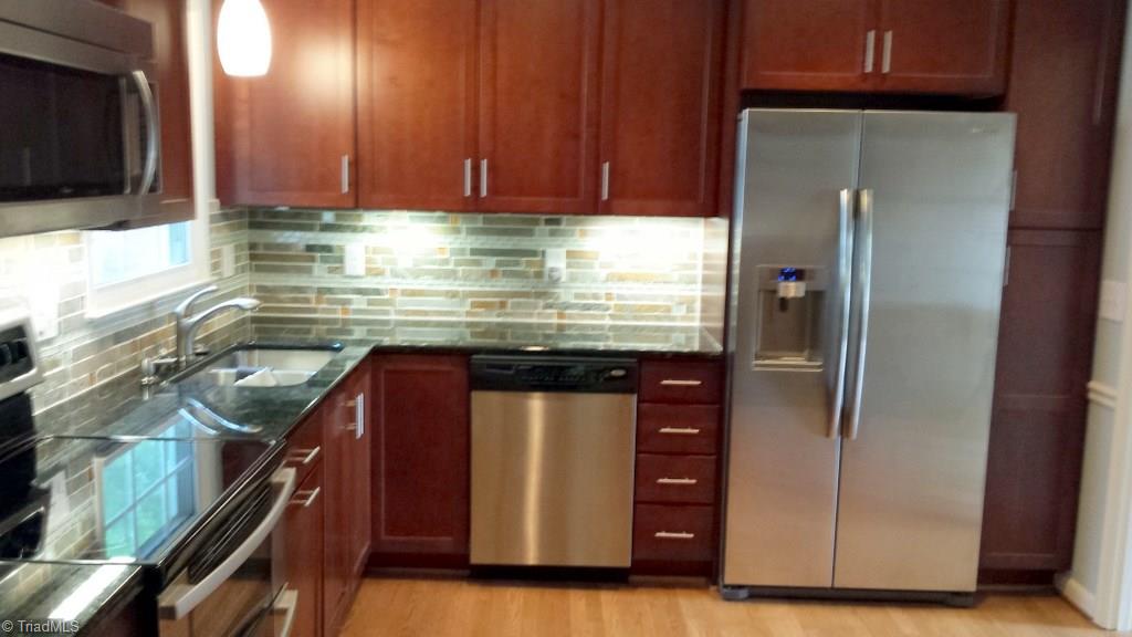 2 Roxby Court Greensboro, NC 27455 - Photo 2 of 4 The kitchen was remodeled in 2012. In addition to new cabinetry, there is recessed lighting, stone/glass back splash, under cabinet lighting, granite countertops, and stainless steel appliances.
