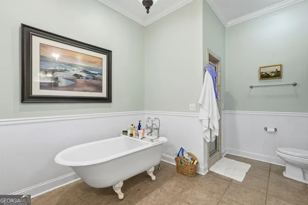 a bathroom with a white tub and shower