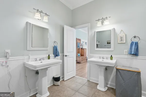 a bathroom with a sink double vanity and a mirror