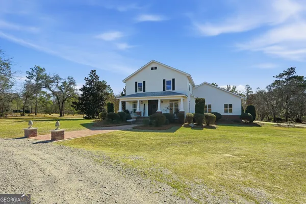 a front view of house with outdoor space and swimming pool