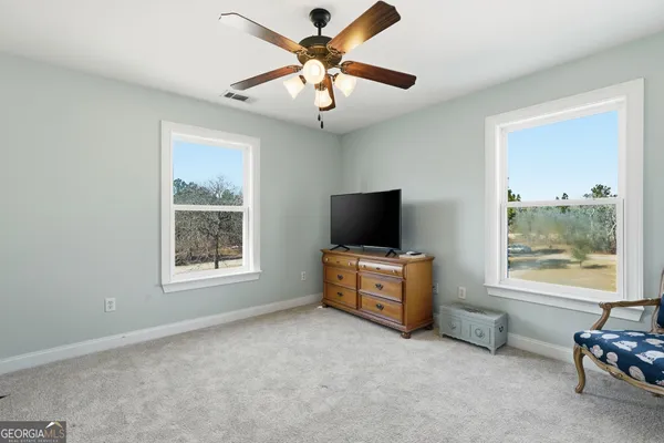 a view of a livingroom with furniture and a flat screen tv