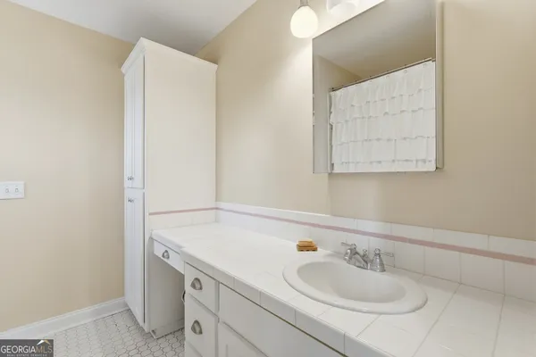 a bathroom with a sink and a mirror