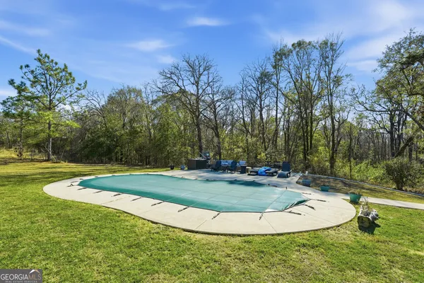 a view of a swimming pool with a yard