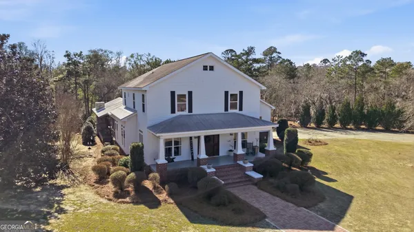 a front view of a house with yard porch and furniture