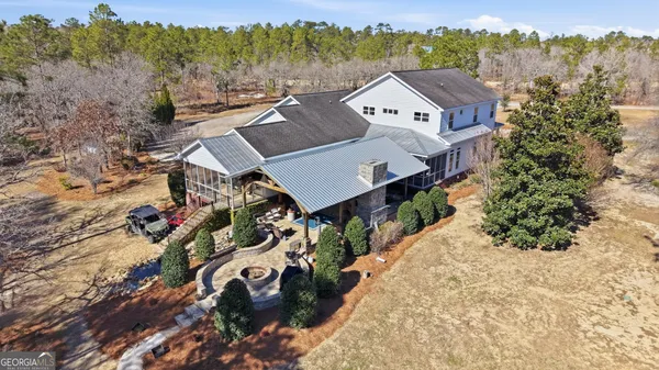 an aerial view of a house with a yard