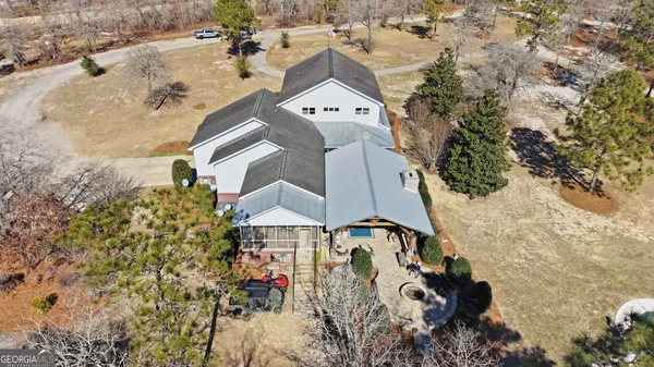 an aerial view of a house with a yard