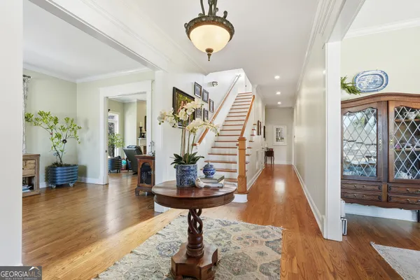 a view of entryway and hall with wooden floor