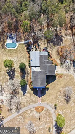 an aerial view of a house with a yard and sitting area