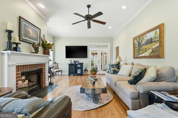 a living room with furniture a fireplace and a flat screen tv