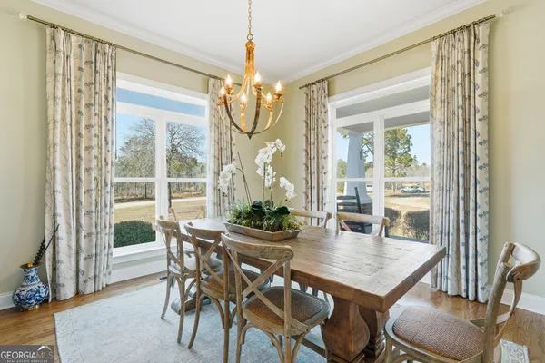 a view of a dining room with furniture wooden floor and chandelier