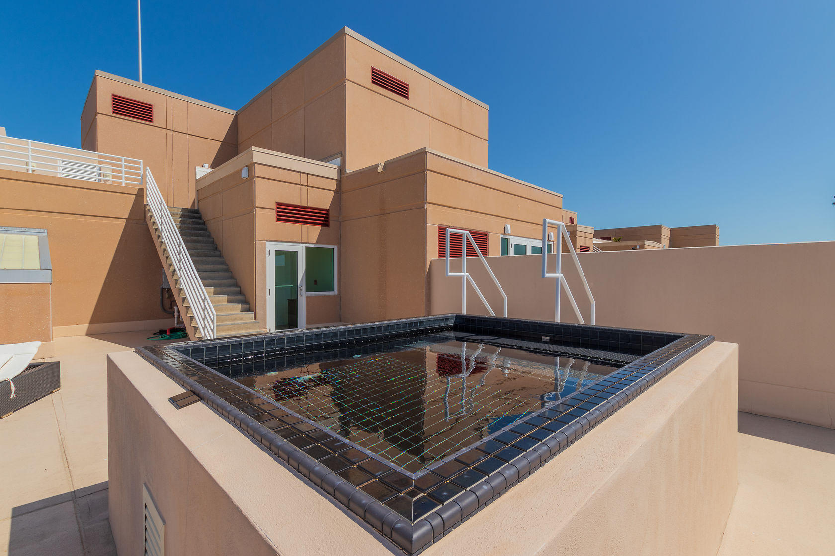 281 Trumbo Road, Unit 205 Key West, FL 33040 - Photo 26 of 35 a view of roof deck with chair and wooden floor