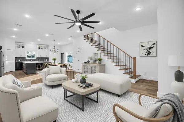a living room with furniture and kitchen view