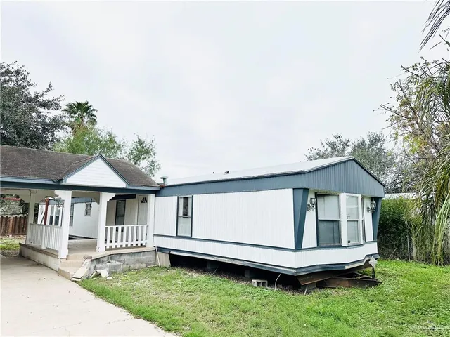 a view of house with a yard and deck