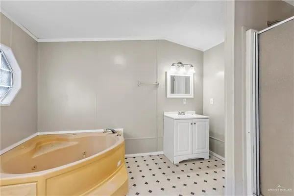 a bathroom with a bathtub sink and mirror