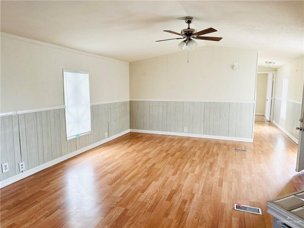 2408 Verbena Avenue Edinburg, TX 78542 - Photo 12 of 19 wooden floor in an empty room with a window