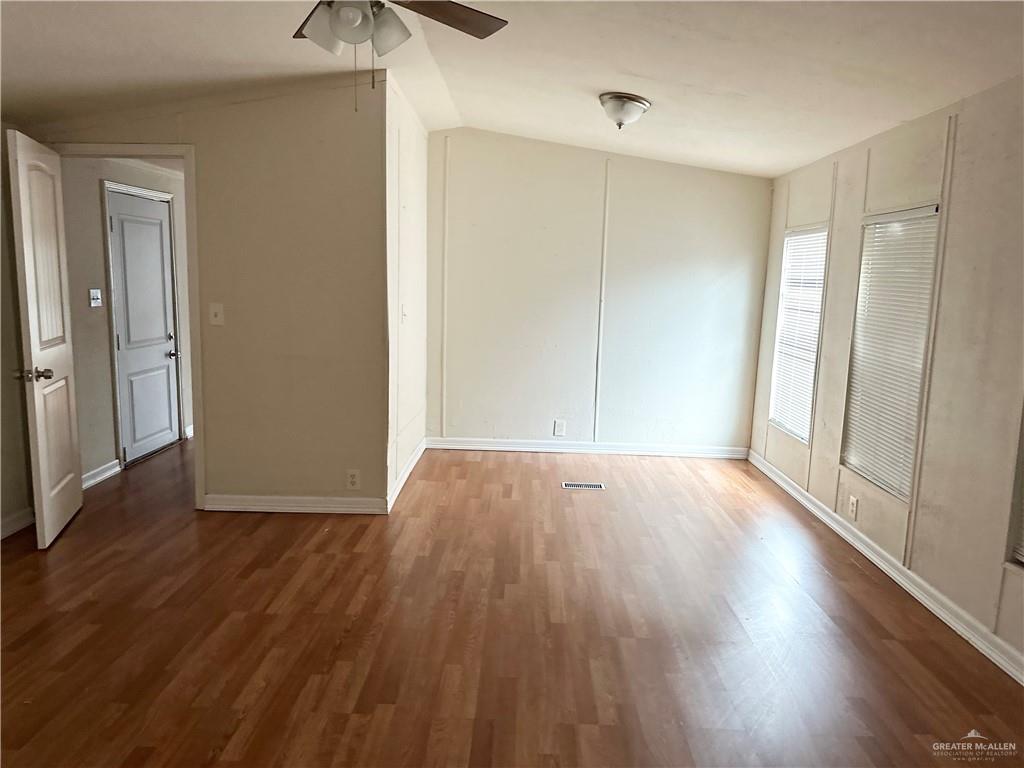 2408 Verbena Avenue Edinburg, TX 78542 - Photo 14 of 19 a view of an empty room with wooden floor and a window