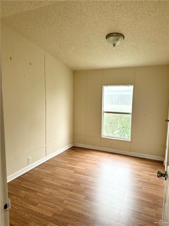 2408 Verbena Avenue Edinburg, TX 78542 - Photo 17 of 19 an empty room with wooden floor and windows