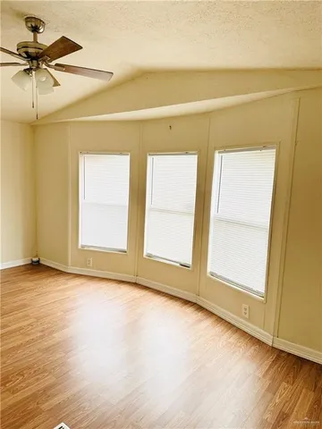 a view of a room with a window and wooden floor
