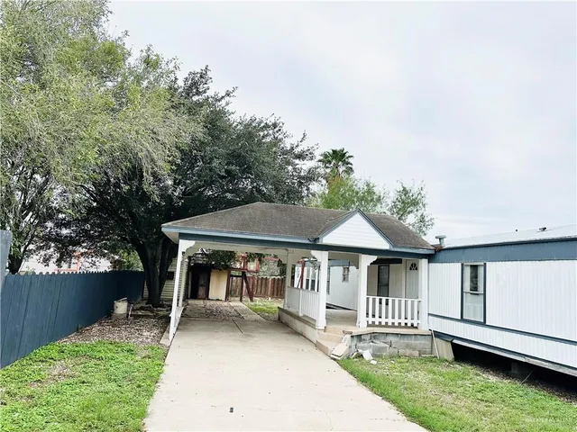 a kitchen with white cabinets a sink a window and stainless steel appliances