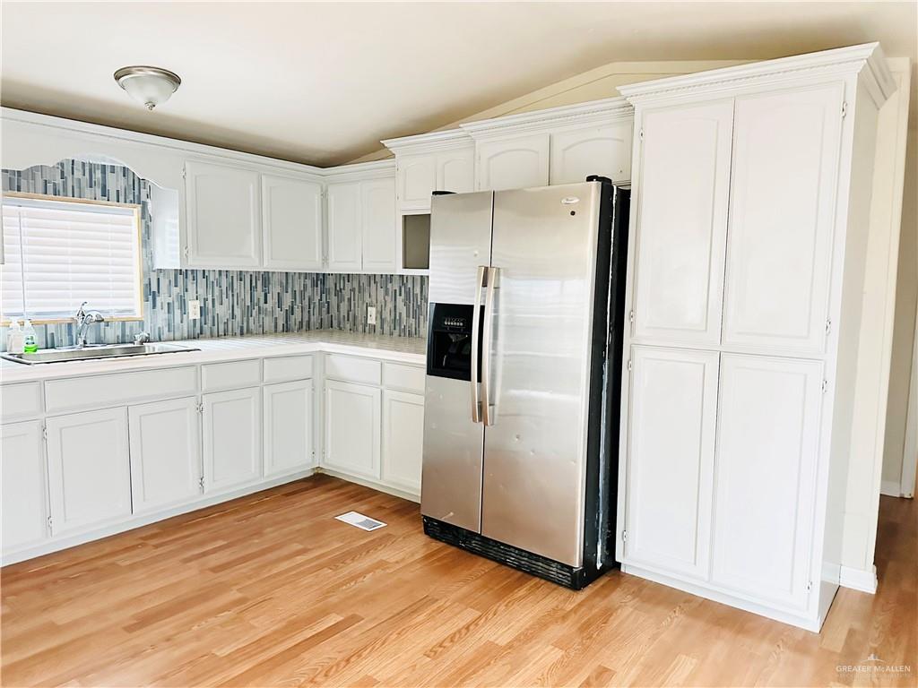 2408 Verbena Avenue Edinburg, TX 78542 - Photo 7 of 19 a kitchen with stainless steel appliances a refrigerator sink and cabinets