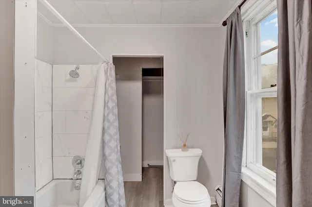a white toilet sitting next to a bathroom sink