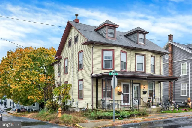 a front view of a residential apartment building with a yard