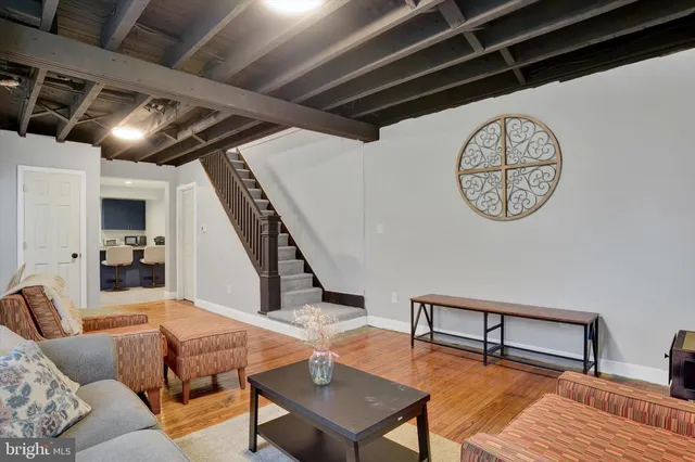 a living room with furniture and a clock