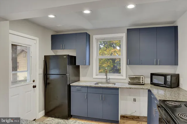 a kitchen with a refrigerator sink and stove