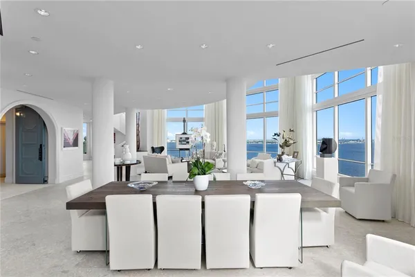 a living room with furniture and a large mirror