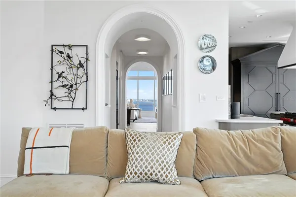 a living room with furniture a rug and white walls