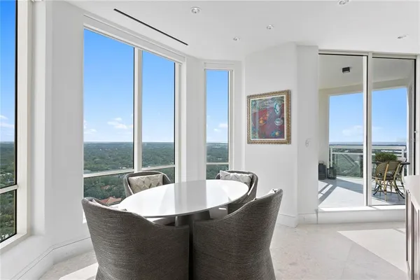 a view of a dining room with furniture and window