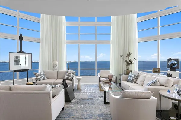 a bedroom with a large bed and a flat tv screen on dresser
