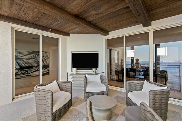 a view of a patio with a table and chairs under an umbrella