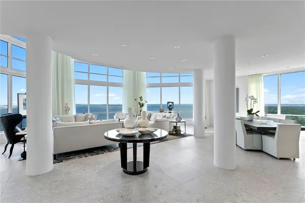 a living room with kitchen island furniture and a large window