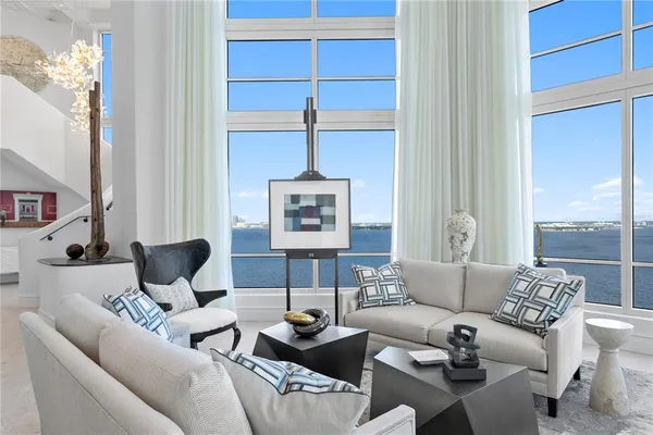 a living room with furniture and a potted plant